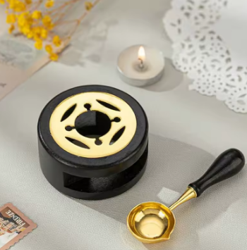 Decorative black and gold object with a small cup on a textured surface.