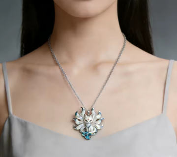 Necklace with a floral pendant worn by a person against a neutral background