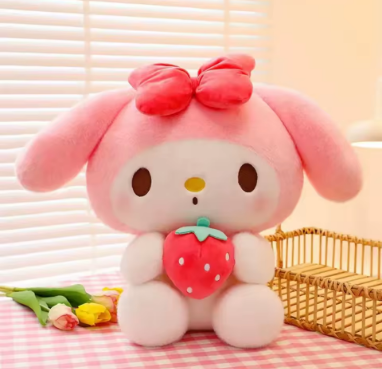 Pink plush toy with a strawberry and bow on a checkered tablecloth