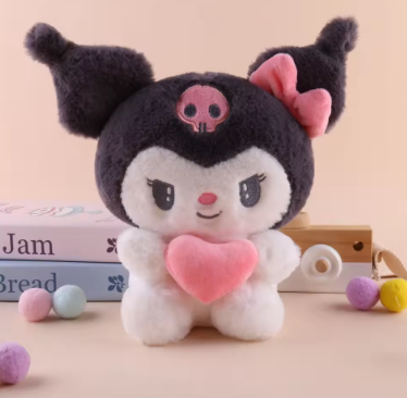 Plush toy with black hair, pink heart, and skull design on a beige background