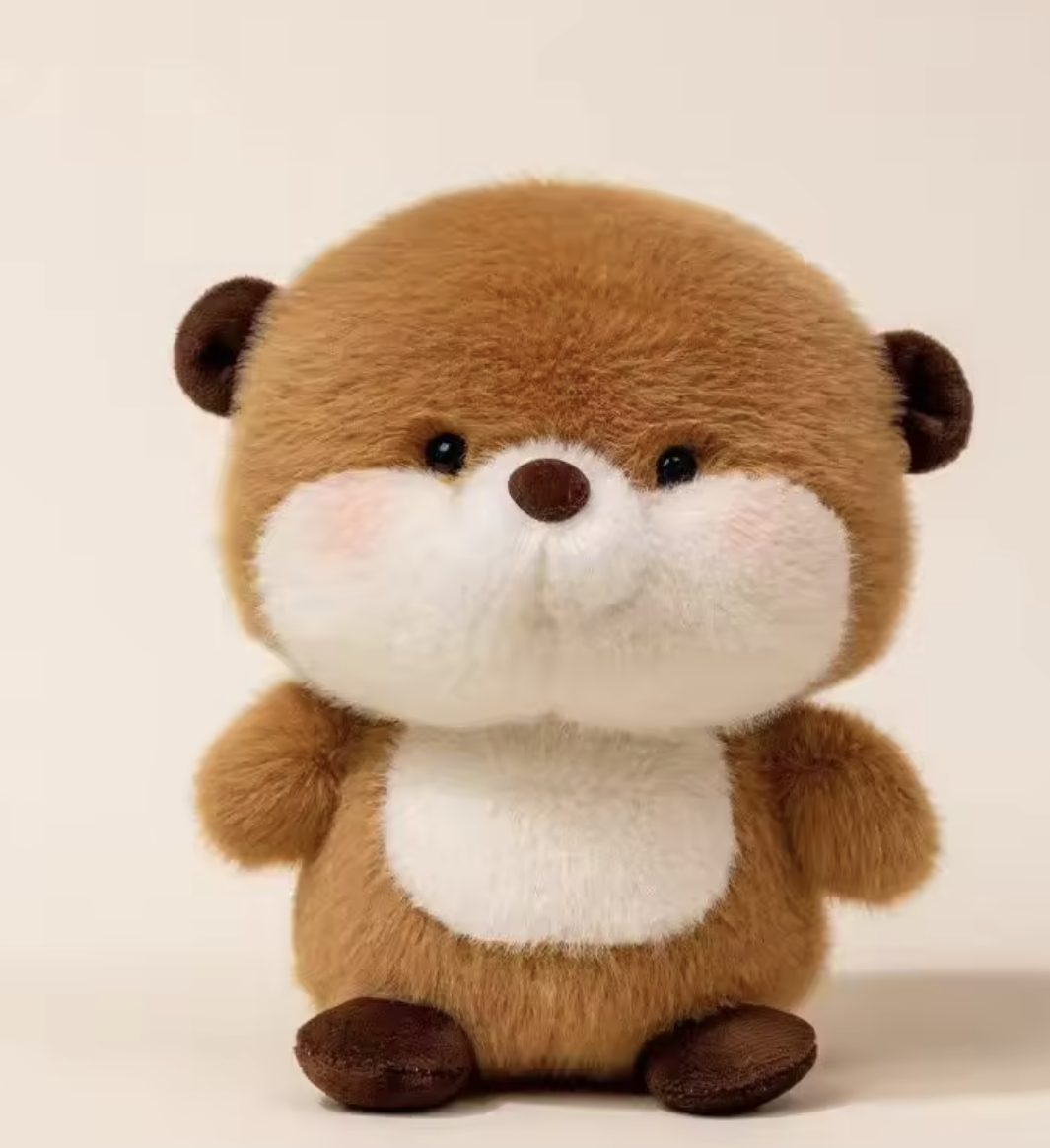Stuffed animal toy resembling an otter on a beige background