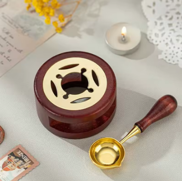 Wooden and brass incense burner with a small bowl on a light background